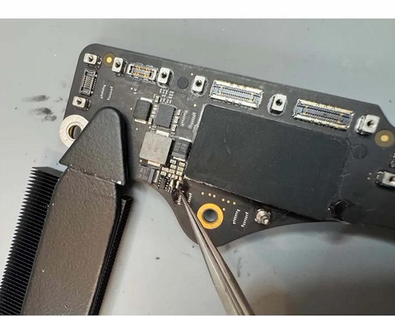 Microsoldering a failed power component on a MacBook logic board at eRepair Chicago
